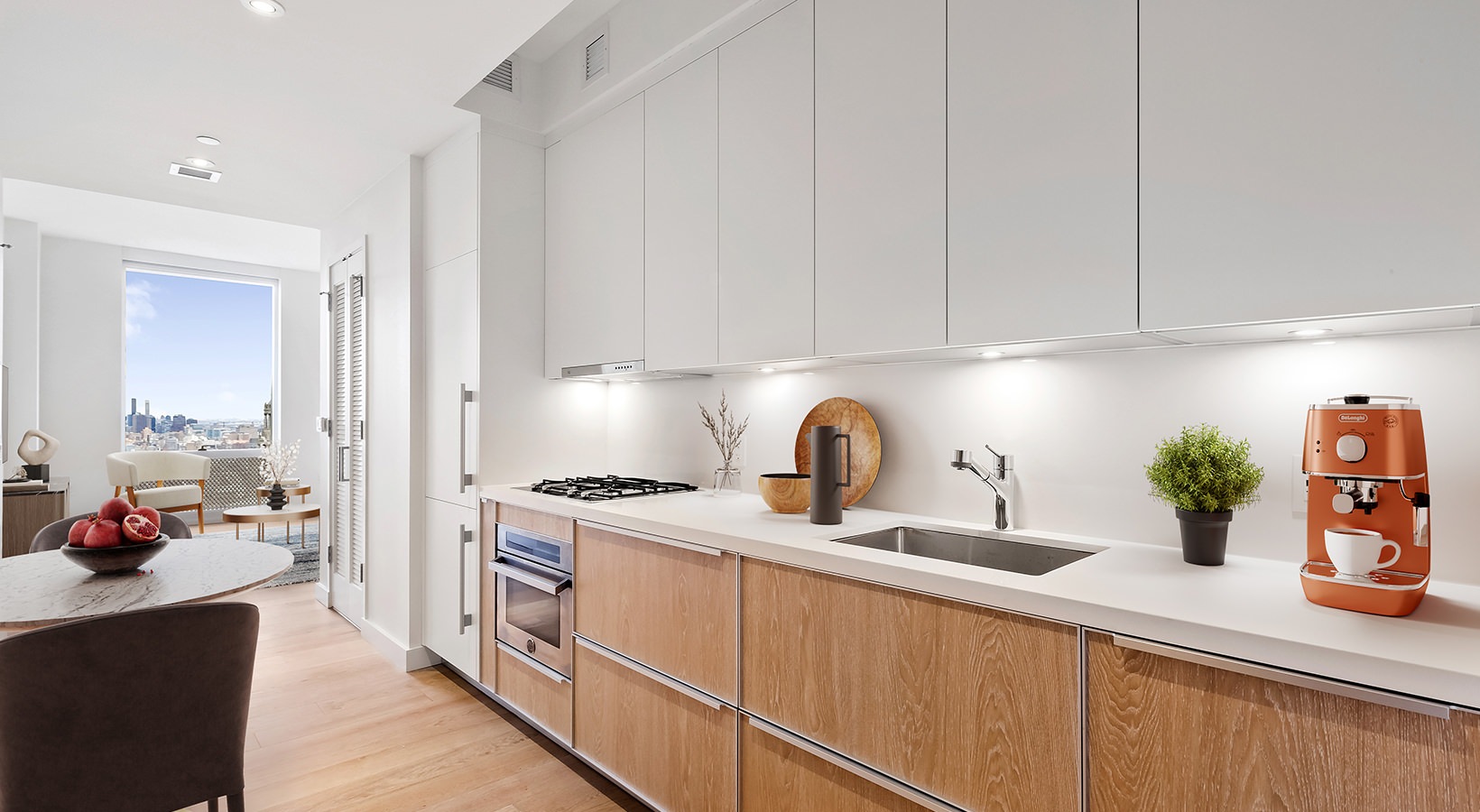 Contemporary kitchen at 19 Dutch featuring wood cabinets, integrated appliances, and city skyline views.