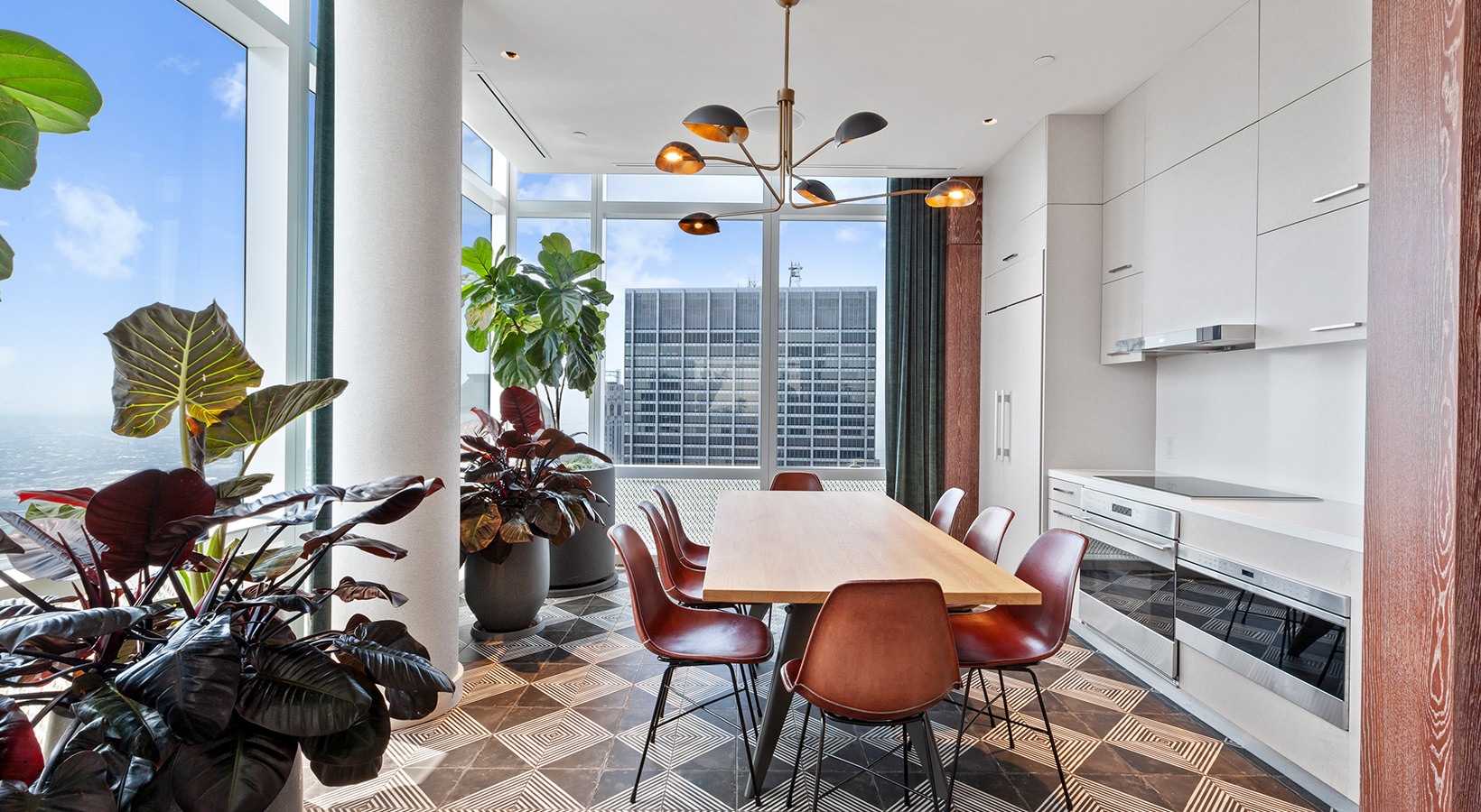Rooftop terrace with dining tables, BBQ grills, and panoramic views of Lower Manhattan and One World Trade Center at 19 Dutch