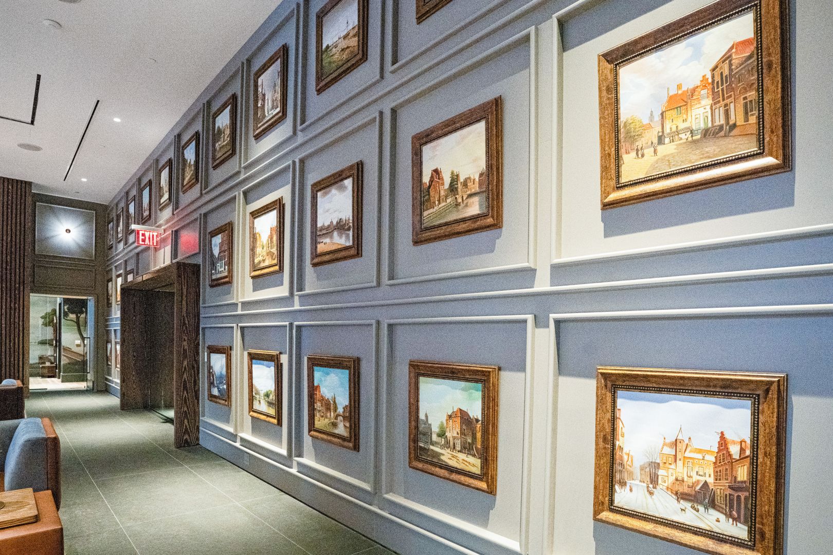 Art-filled hallway at 19 Dutch, Lower Manhattan apartment for rent featuring framed paintings
