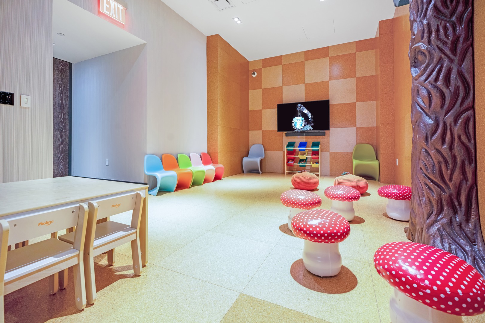 Colorful children’s playroom at 19 Dutch with playful seating, activity tables, and a TV area in Lower Manhattan.
