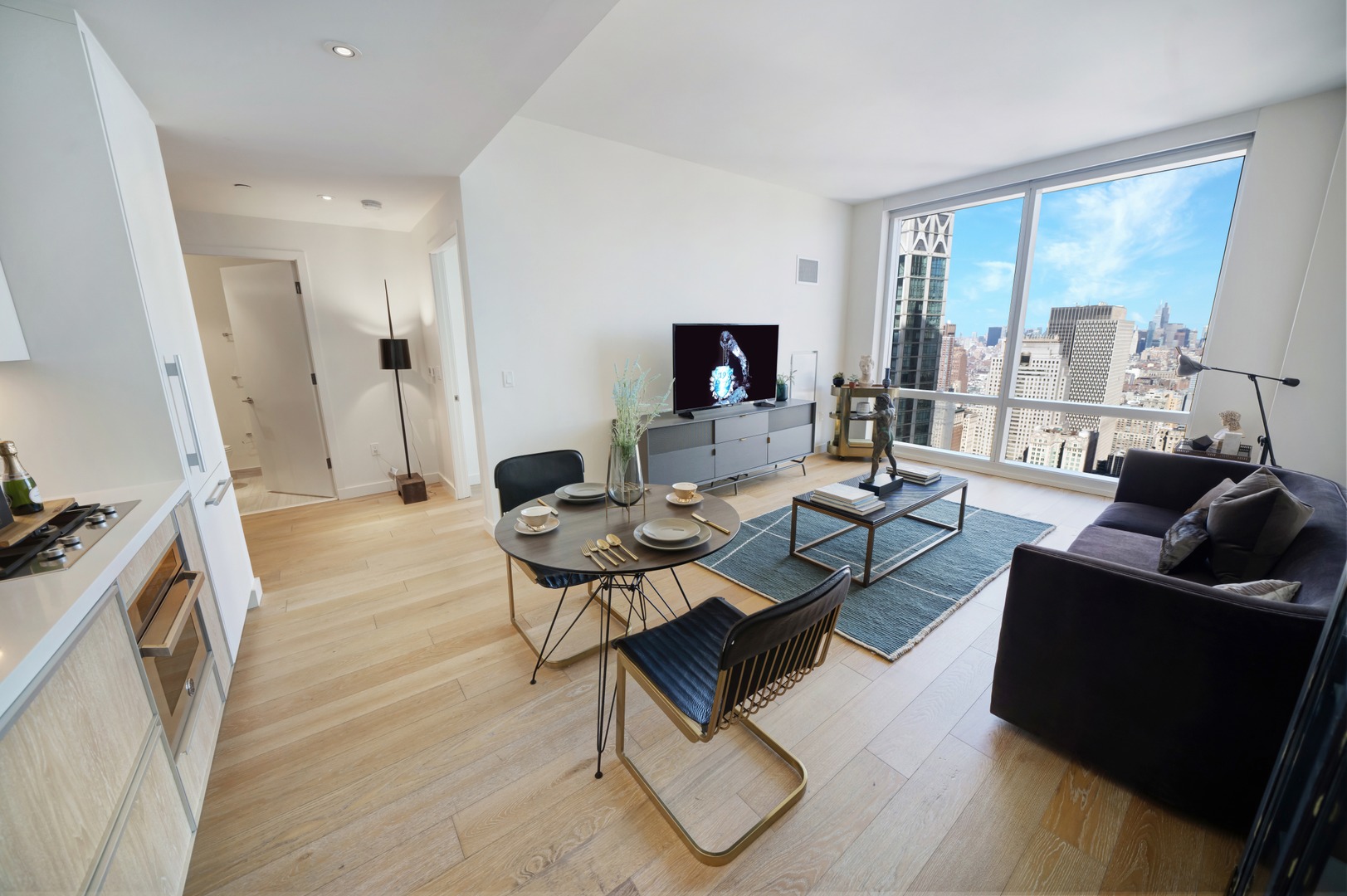 Open-layout living room at 19 Dutch with floor-to-ceiling windows, hardwood floors, and dramatic Manhattan views.