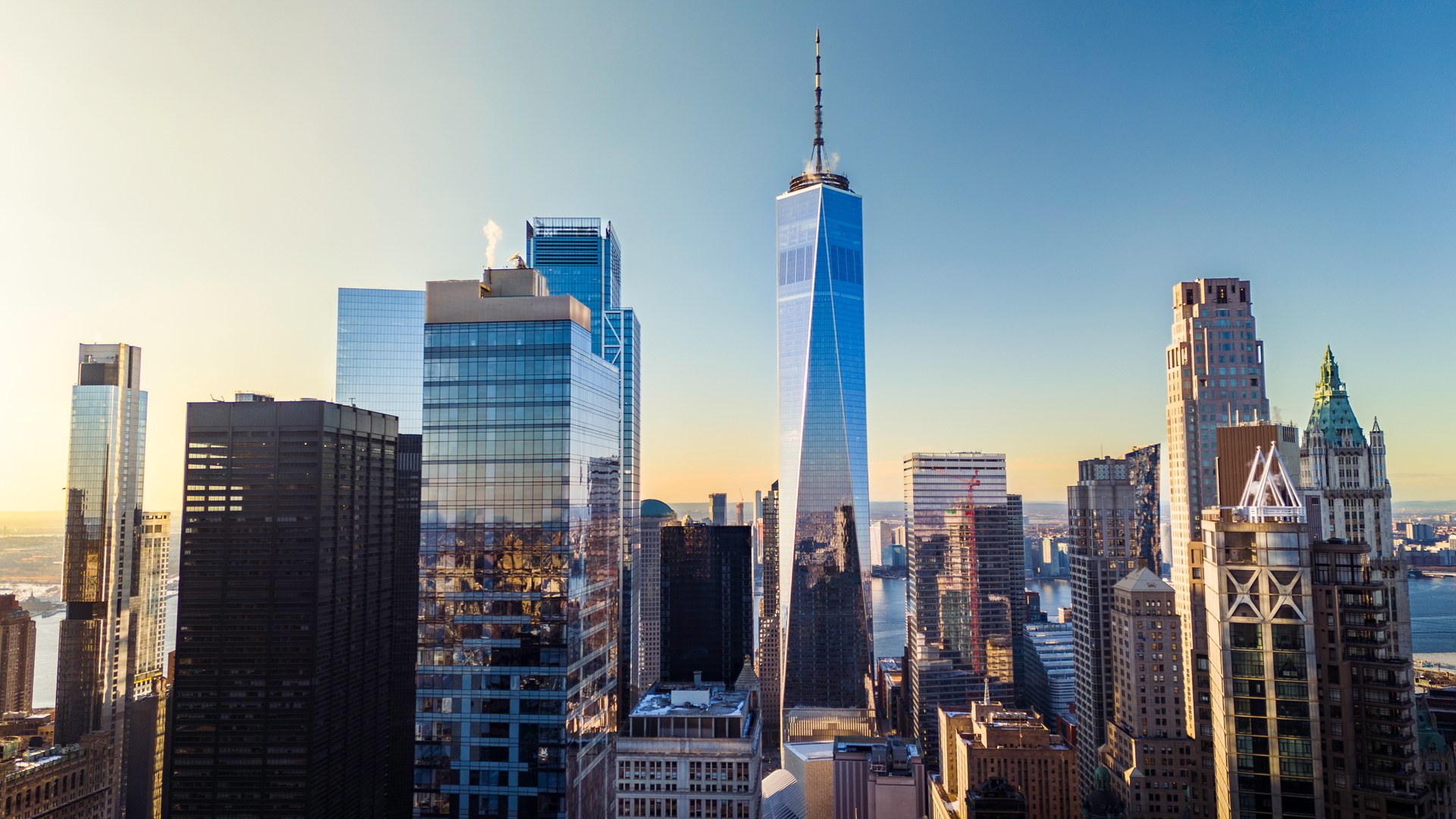 Sunlit skyline view featuring One World Trade Center and surrounding Lower Manhattan towers at 19 Dutch