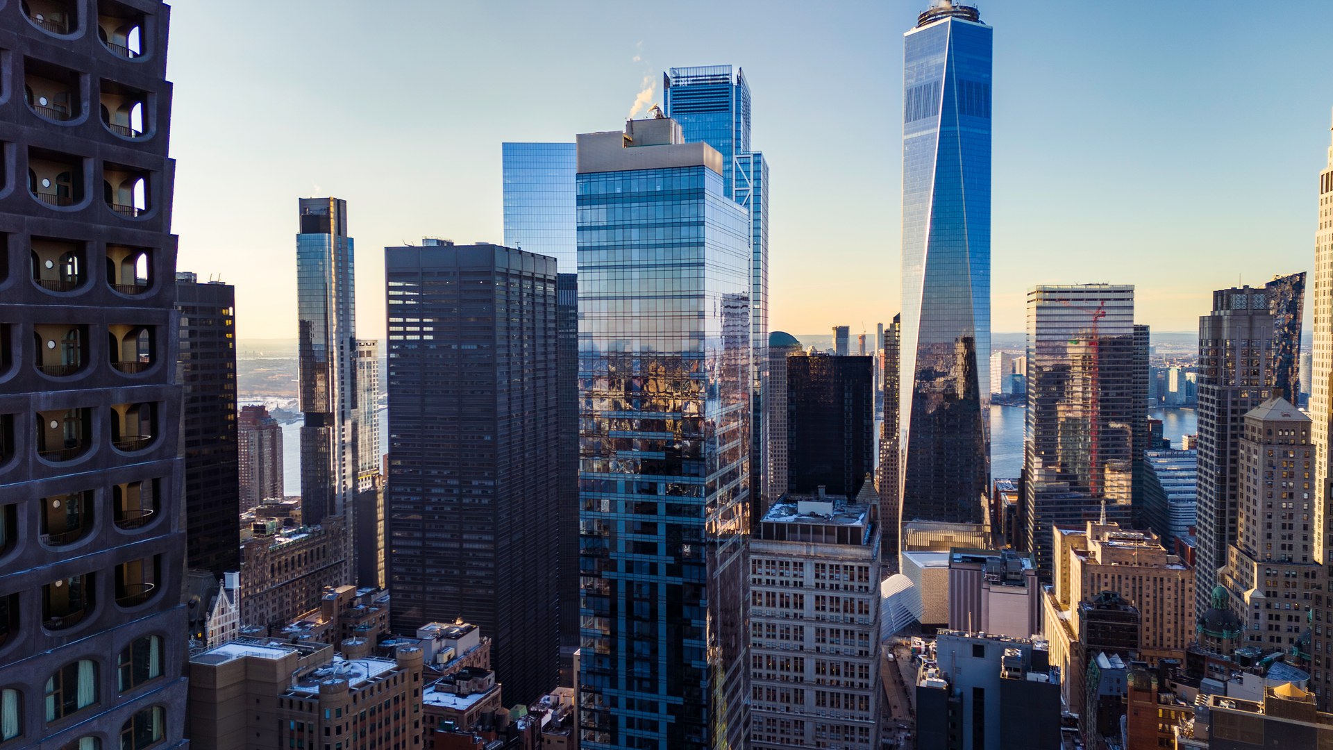 Sunrise cityscape featuring One World Trade Center and surrounding glass towers in Lower Manhattan at 19 Dutch