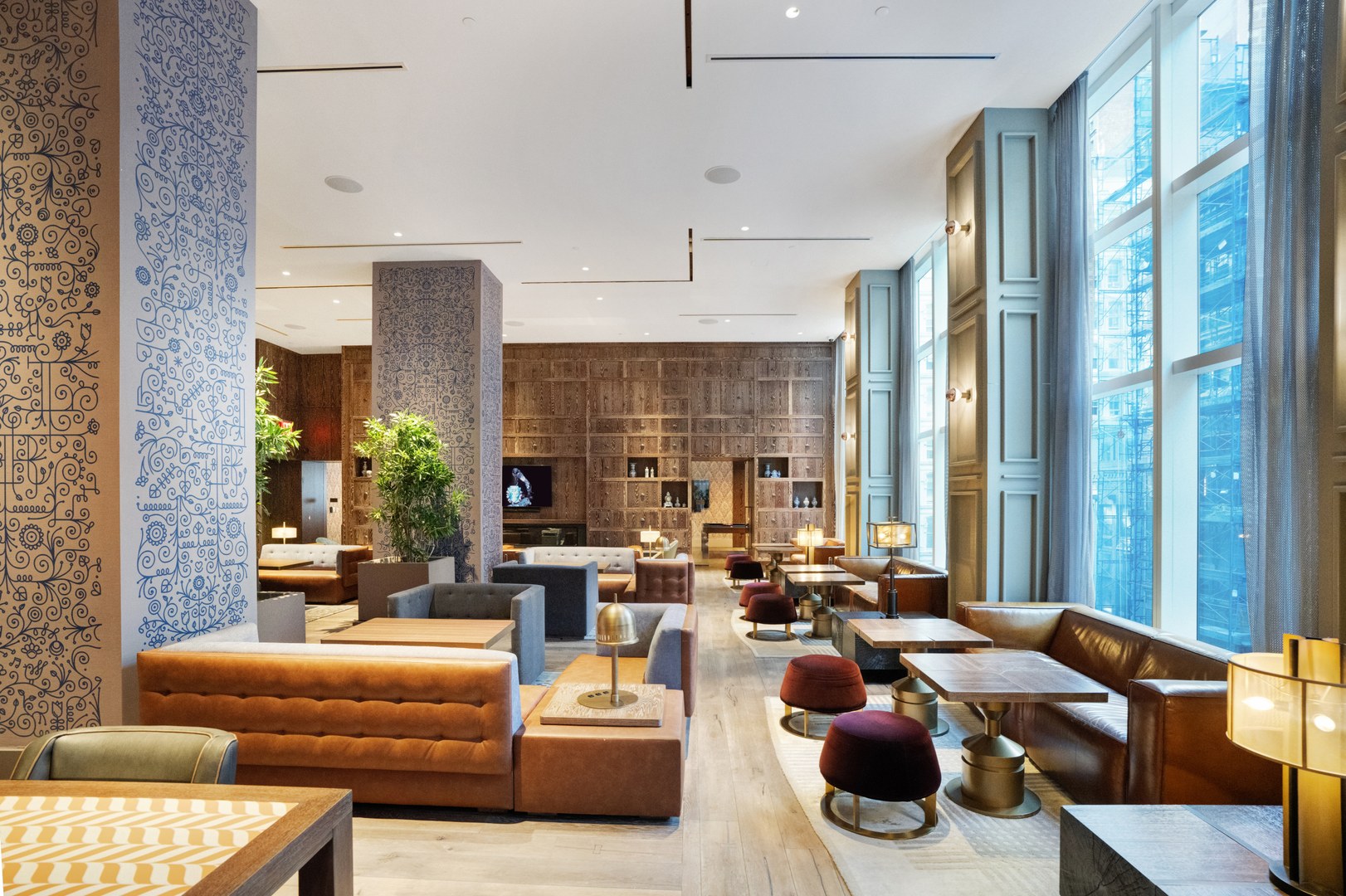 Spacious resident lounge at 19 Dutch featuring modern seating, tall windows, and boutique design in Lower Manhattan.