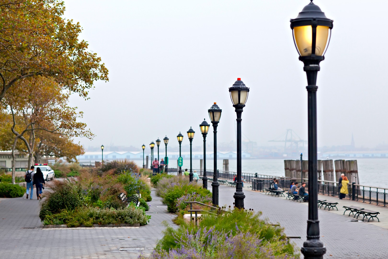 Peaceful riverside walkway lined with classic street lights and greenery in Downtown NYC near 19 Dutch